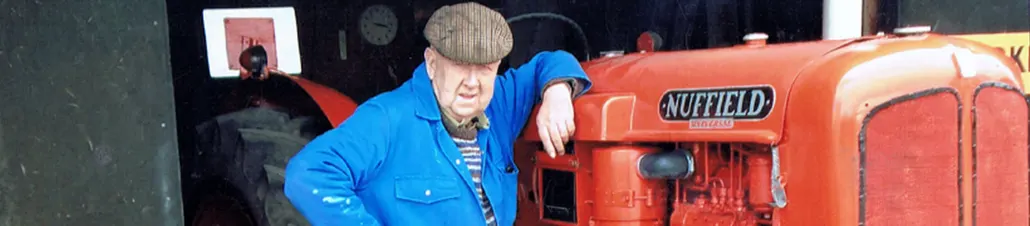 Mr Webster Senior leaning proudly on a vintage Nuffield tractor on the family farm